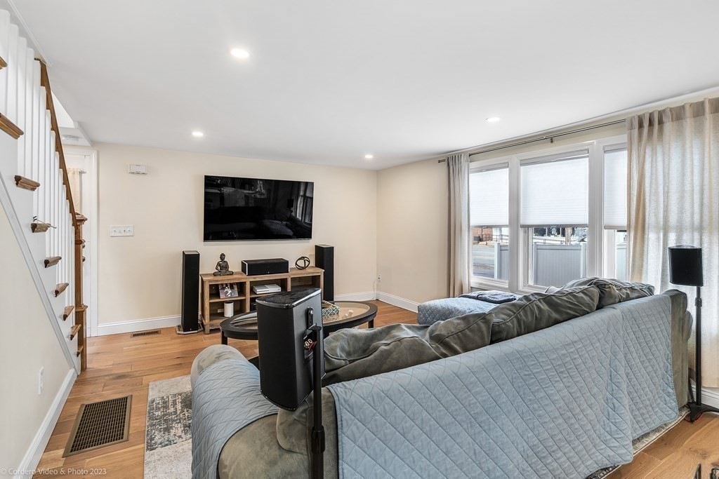 26 Mill Street Maynard, MA 01754 - Photo 19 of 29 a living room with furniture and a flat screen tv