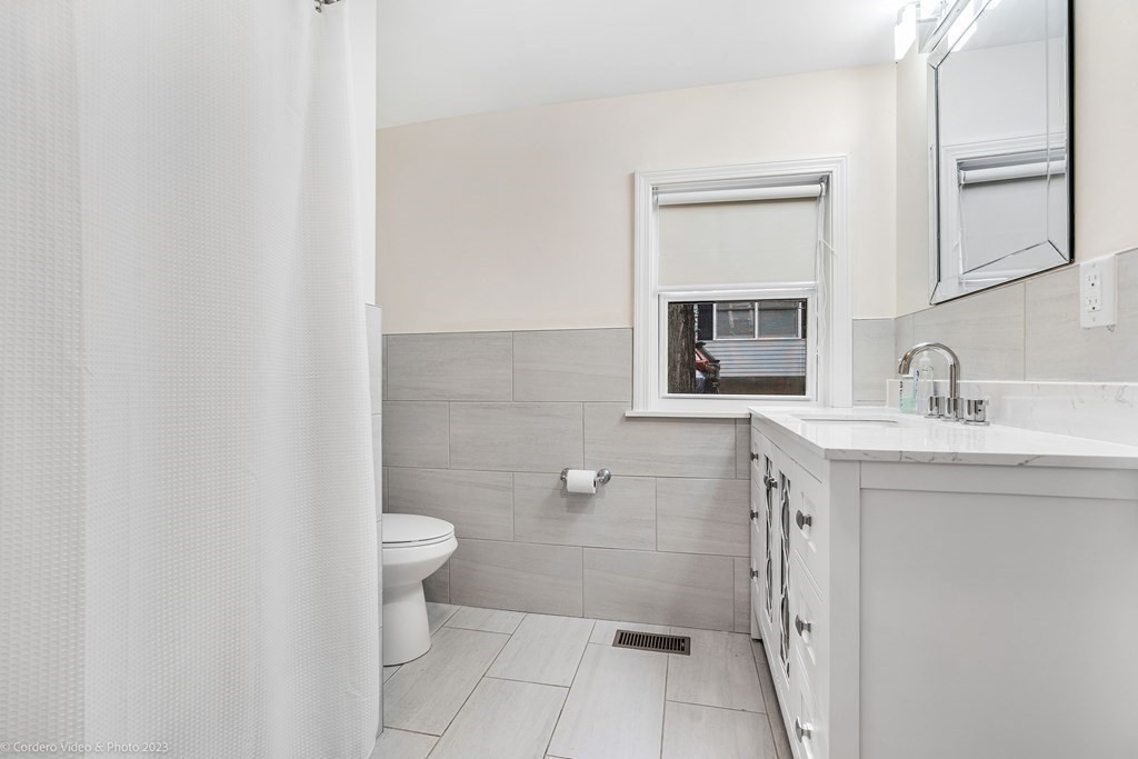 26 Mill Street Maynard, MA 01754 - Photo 21 of 29 a bathroom with a sink a toilet and shower