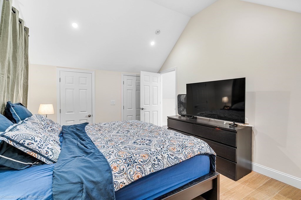 26 Mill Street Maynard, MA 01754 - Photo 24 of 29 a bedroom with a bed and a flat screen television