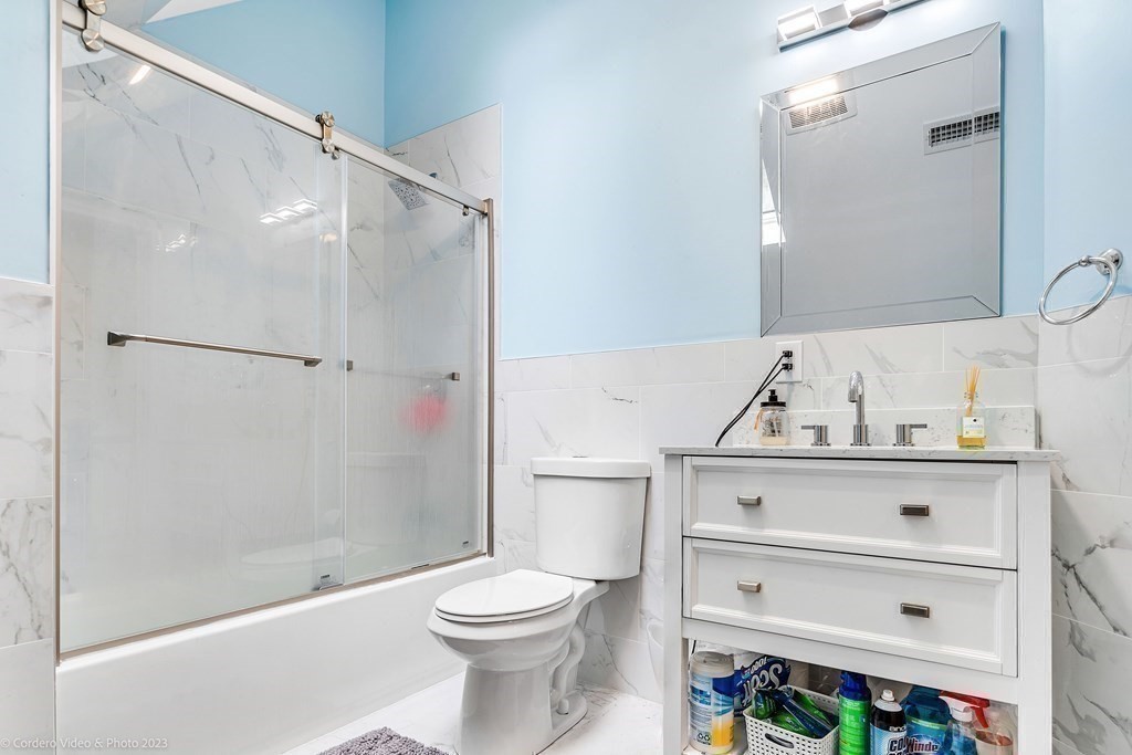 26 Mill Street Maynard, MA 01754 - Photo 28 of 29 a bathroom with a white toilet and a shower