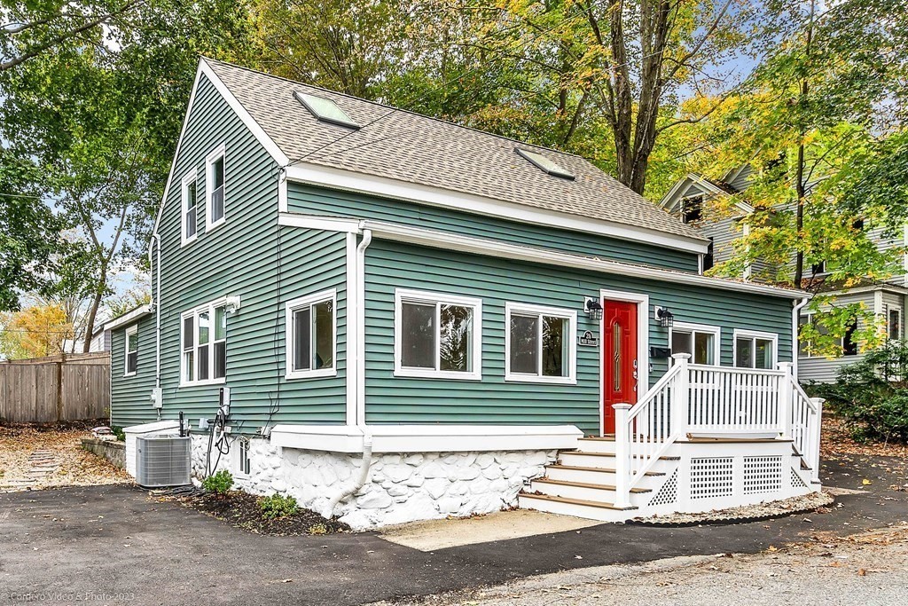 26 Mill Street Maynard, MA 01754 - Photo 5 of 29 a front view of a house with a garage