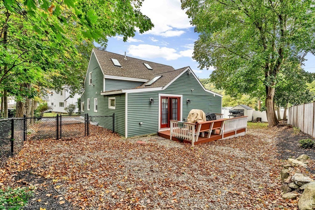 26 Mill Street Maynard, MA 01754 - Photo 9 of 29 a view of a house with a yard and sitting area