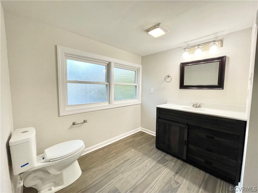 11300 Buckley Hall Road Mathews, VA 23109 - Photo 20 of 31 a bathroom with a toilet sink double vanity and mirror