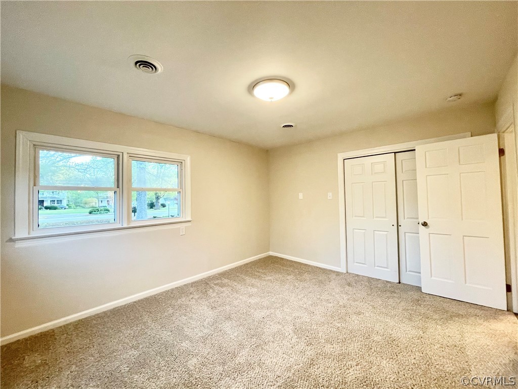 11300 Buckley Hall Road Mathews, VA 23109 - Photo 10 of 31 a view of an empty room with a window