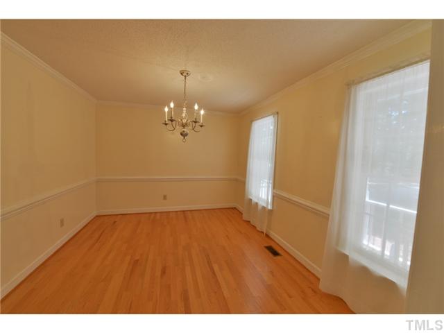 13612 Durant Road Raleigh, NC 27614 - Photo 5 of 20 a view of a room with wooden floor and a chandelier