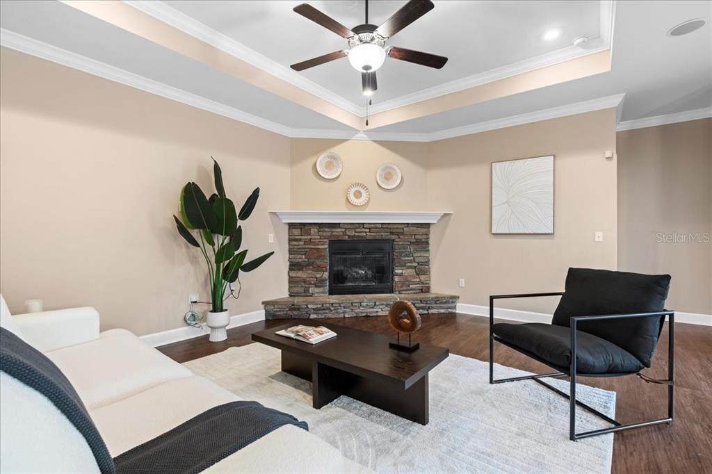 9834 Northwest 17th Road Gainesville, FL 32606 - Photo 11 of 51 a living room with furniture a fireplace and a chandelier