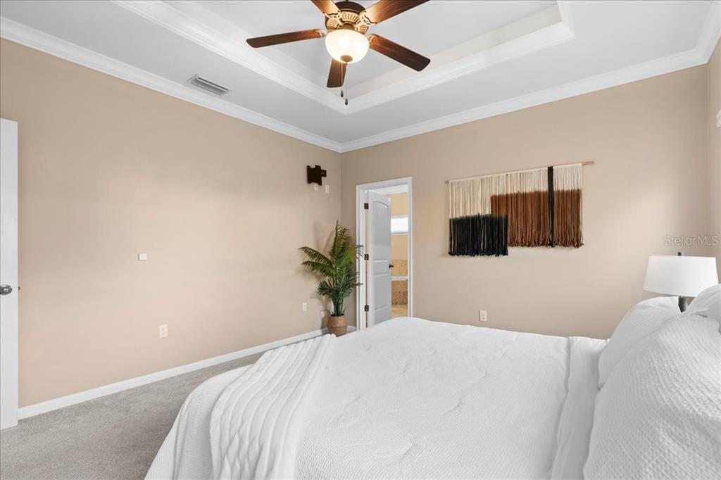 9834 Northwest 17th Road Gainesville, FL 32606 - Photo 16 of 51 a bedroom with a bed and a potted plant