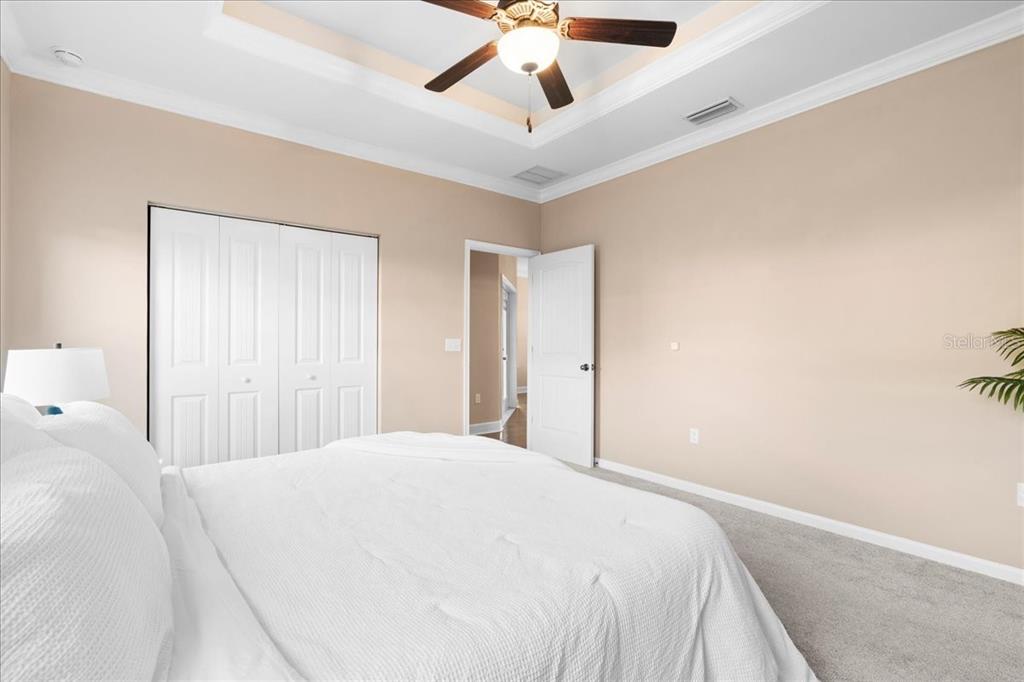 9834 Northwest 17th Road Gainesville, FL 32606 - Photo 17 of 51 a spacious bedroom with a bed and a ceiling fan