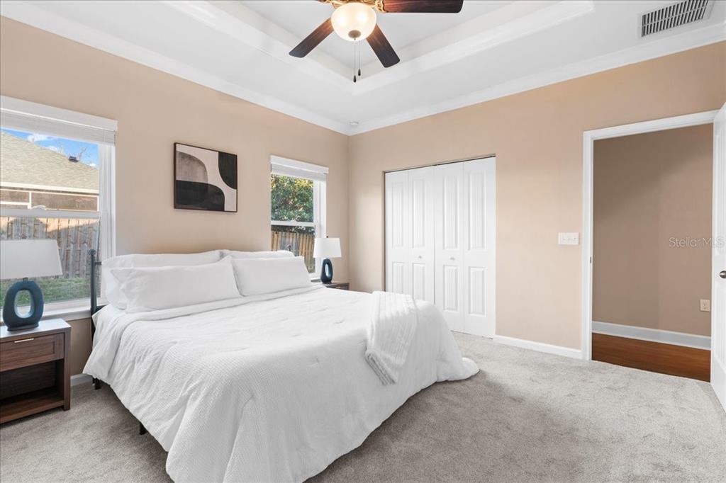 9834 Northwest 17th Road Gainesville, FL 32606 - Photo 18 of 51 a bedroom with a large bed a chandelier and a window