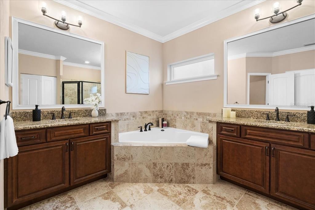 9834 Northwest 17th Road Gainesville, FL 32606 - Photo 19 of 51 a bathroom with a tub sink and mirror