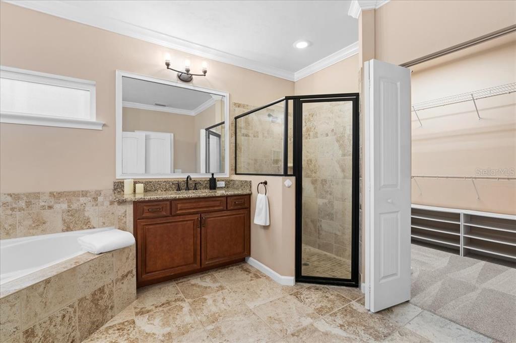 9834 Northwest 17th Road Gainesville, FL 32606 - Photo 20 of 51 a bathroom with a granite countertop sink mirror and bathtub
