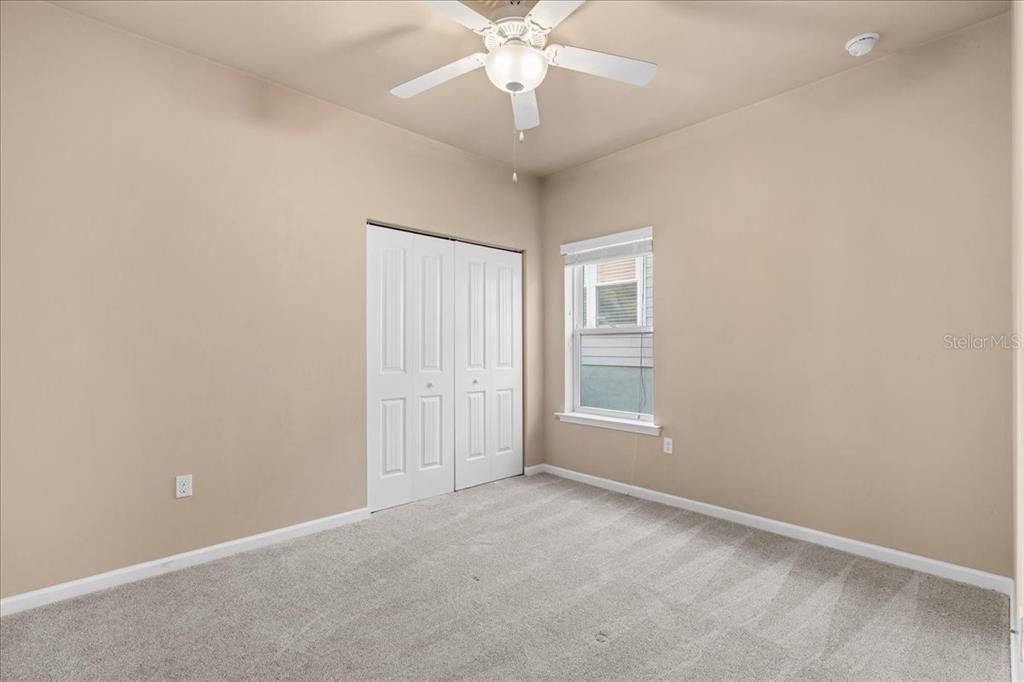 9834 Northwest 17th Road Gainesville, FL 32606 - Photo 23 of 51 an empty room with chandelier fan and windows