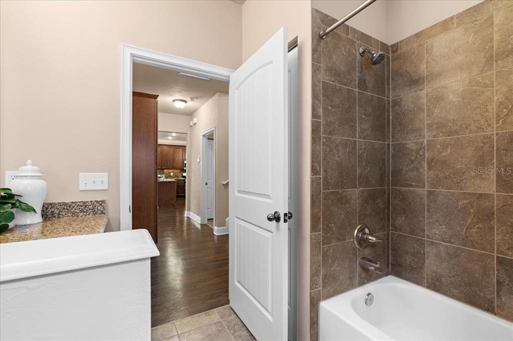 9834 Northwest 17th Road Gainesville, FL 32606 - Photo 24 of 51 a bathroom with a shower a sink and a mirror
