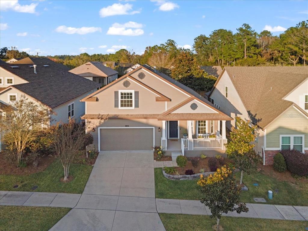 9834 Northwest 17th Road Gainesville, FL 32606 - Photo 46 of 51 a front view of a house with a yard and trees