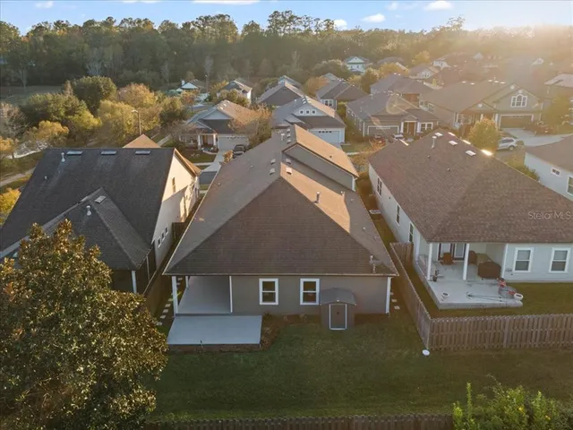 an aerial view of house with yard