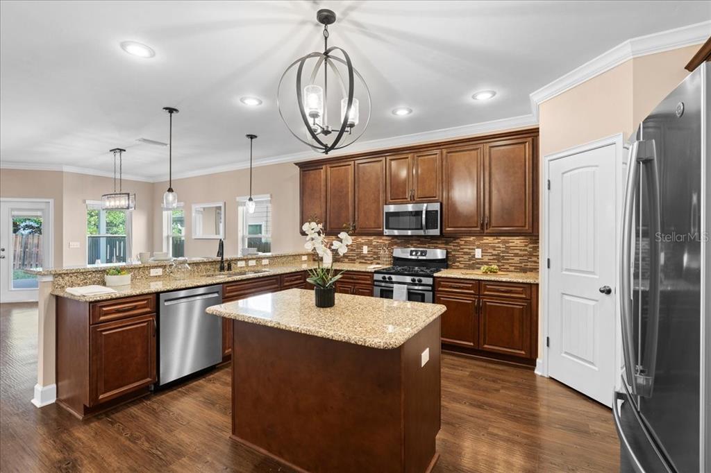 9834 Northwest 17th Road Gainesville, FL 32606 - Photo 6 of 51 a kitchen with stainless steel appliances granite countertop a sink stove and refrigerator