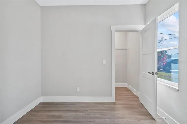 a view of an empty room with wooden floor