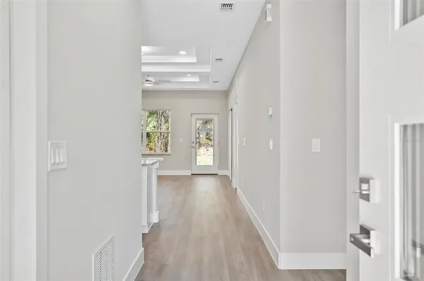 a view of an entryway with wooden floor