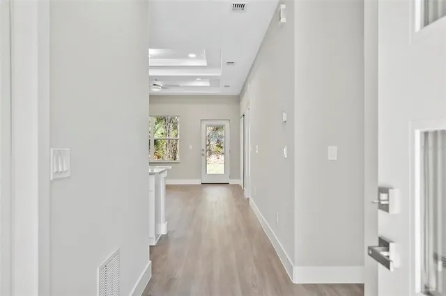 a view of an entryway with wooden floor