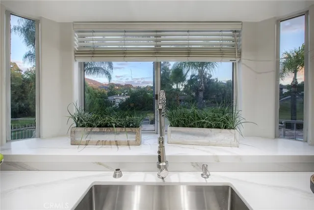 a kitchen with a sink and large window