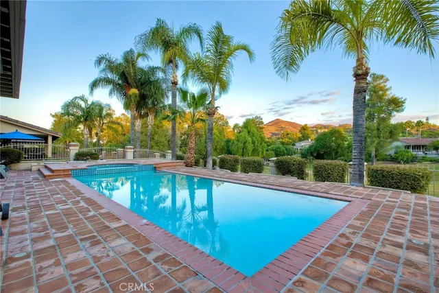 a view of house with swimming pool outdoor seating