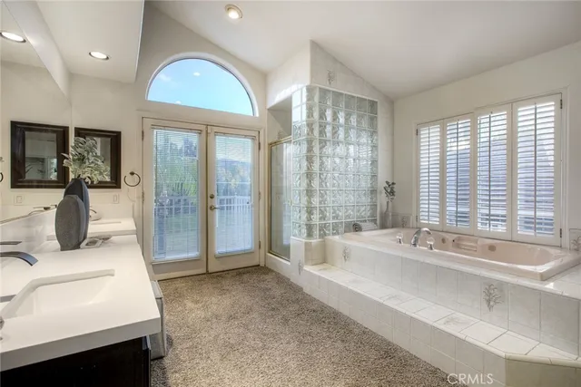 an empty room with windows fireplace and fan