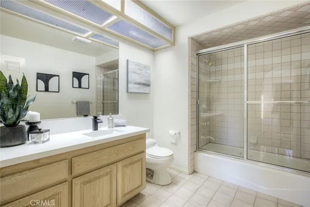 a bathroom with double vanity sink and a mirror