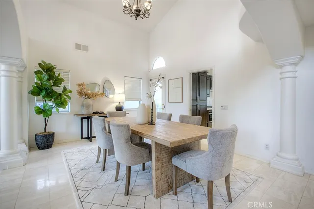 a view of a dining room with furniture and a potted plant