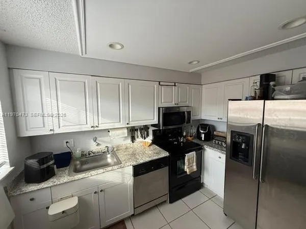 a kitchen with a sink a stove and refrigerator
