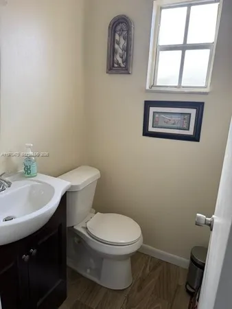 a white toilet sitting next to a bathroom sink