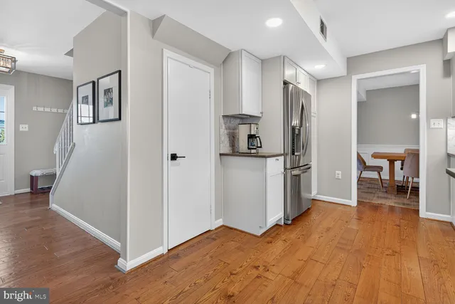 a kitchen with stainless steel appliances a refrigerator and a stove top oven