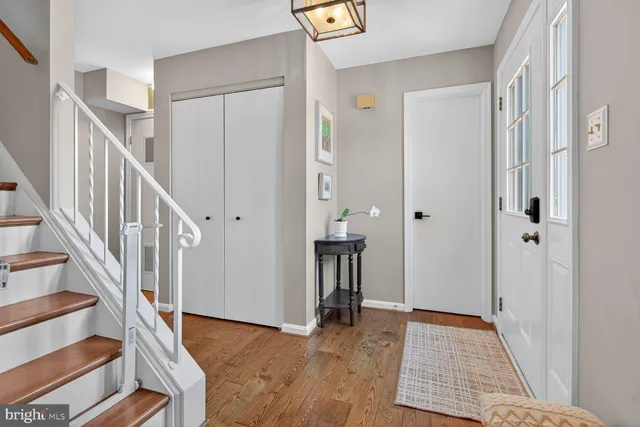 a view of entryway and hall with wooden floor