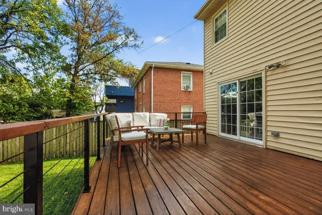 a view of a patio with table and chairs with wooden floor and fence