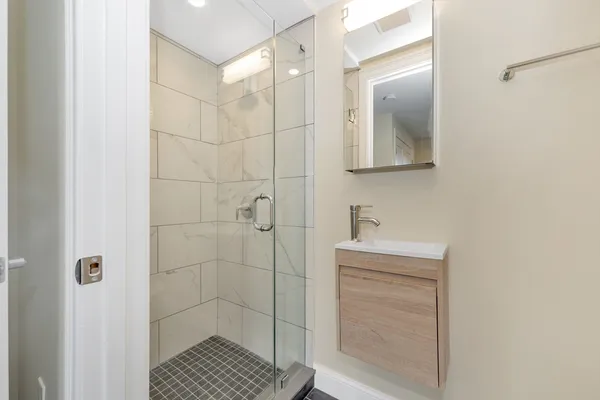 a bathroom with a toilet a sink and mirror