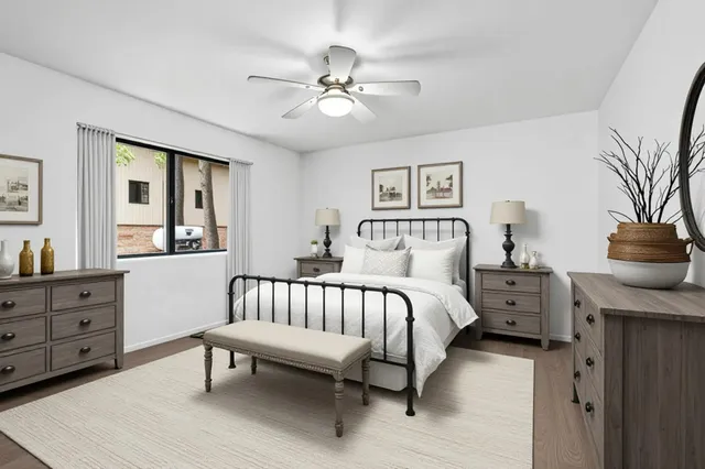 a spacious bedroom with a bed and a chandelier