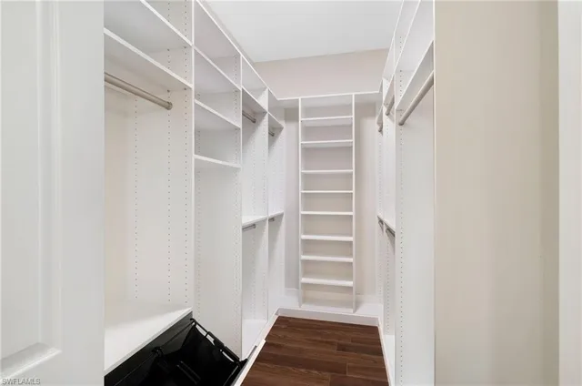 a bathroom with a granite countertop sink a toilet a shower and a mirror