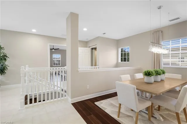 a spacious bedroom with a bed and wooden floor