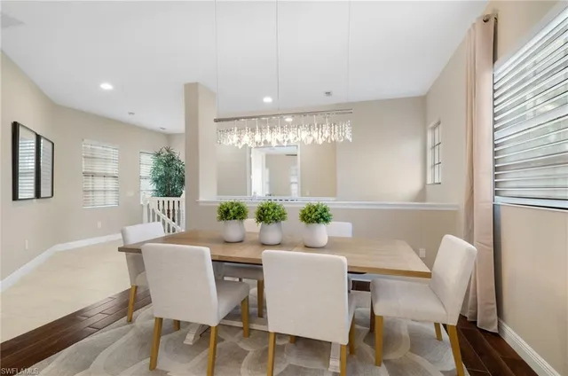 a kitchen with refrigerator and chairs