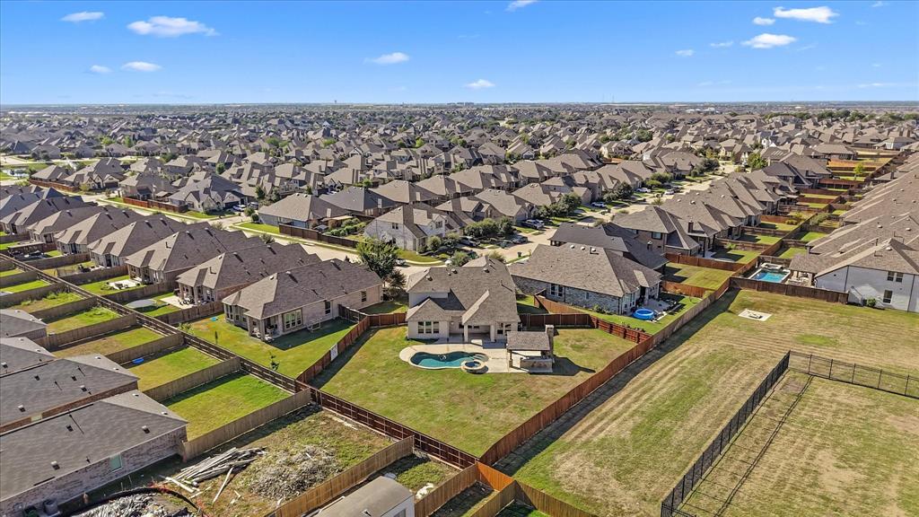 2044 Longbridge Road Forney, TX 75126 - Photo 33 of 40 Spacious backyard featuring a fenced perimeter, inground pool with integrated spa, and an expansive lawn area