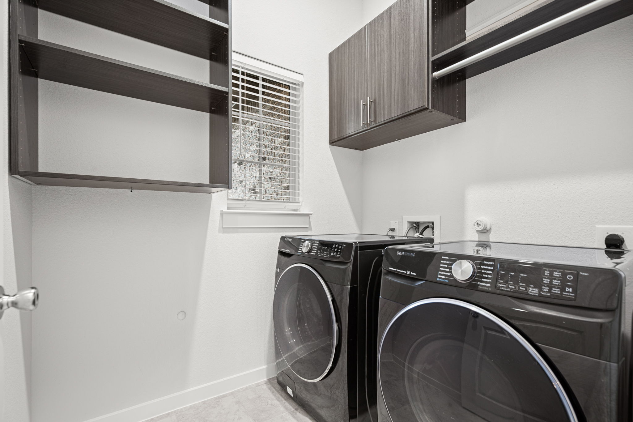 841 Spinnaker Loop Kyle, TX 78640 - Photo 23 of 40 Washroom with independent washer and dryer and cabinet space