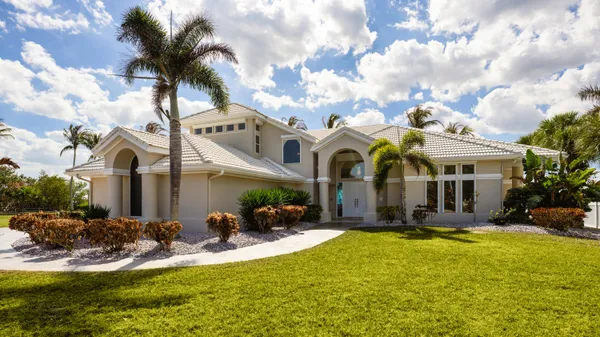 a view of a house with swimming pool and sitting area