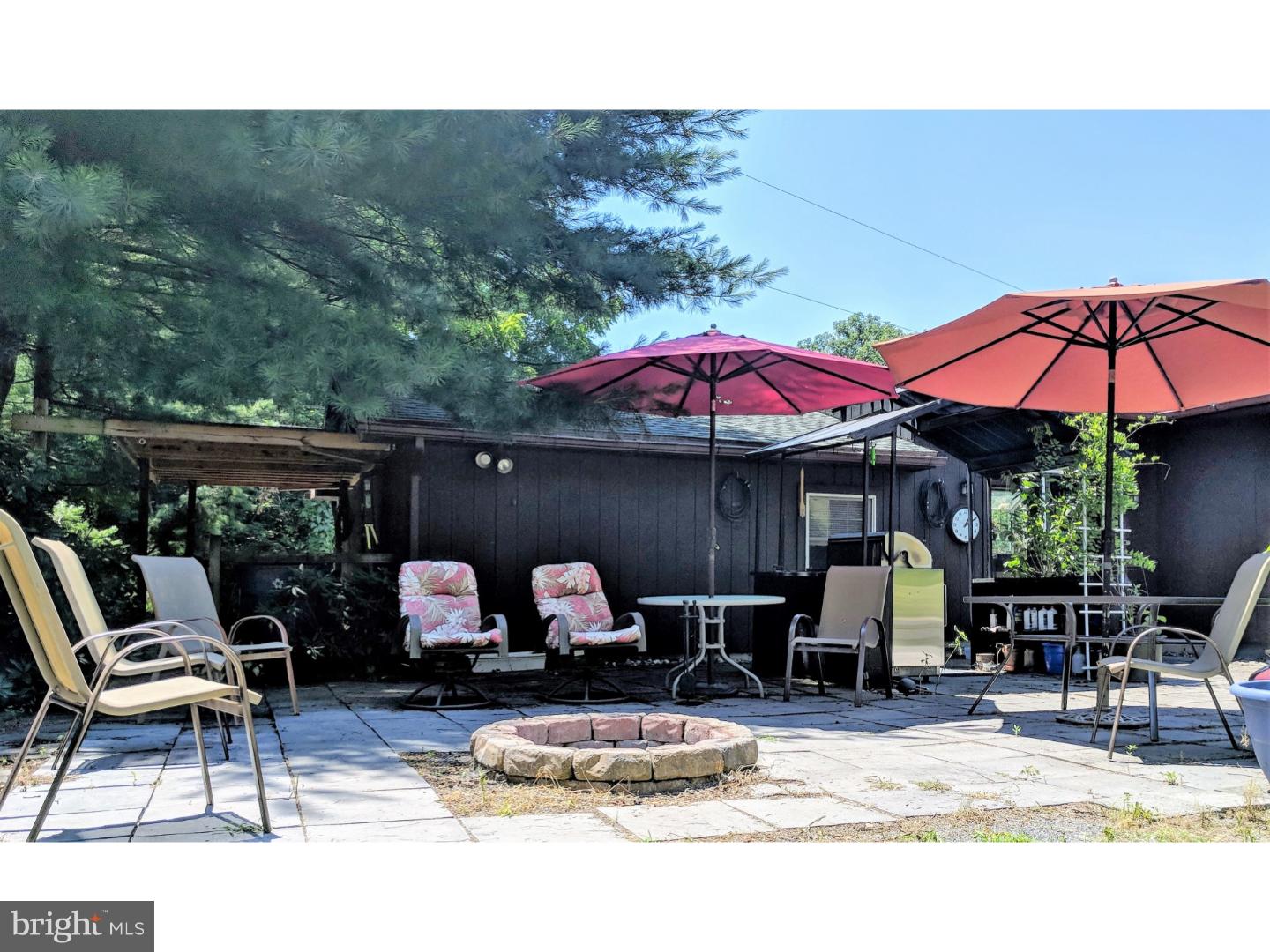 1144 Upper Van Reed Road Leesport, PA 19533 - Photo 24 of 25 a patio with a table and chairs under an umbrella