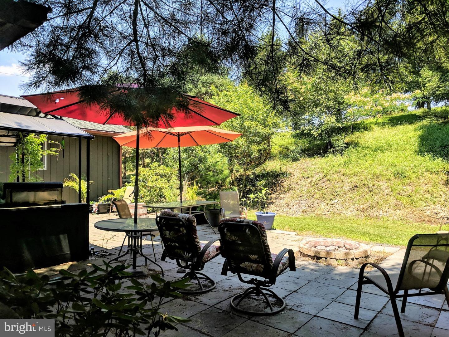 1144 Upper Van Reed Road Leesport, PA 19533 - Photo 25 of 25 a view of a patio with lawn chairs under an umbrella
