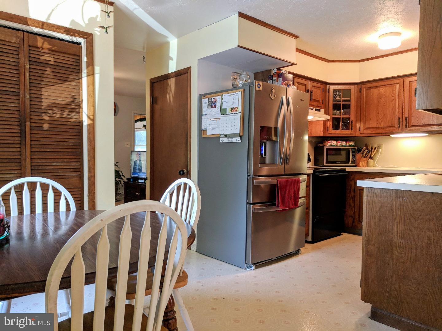 1144 Upper Van Reed Road Leesport, PA 19533 - Photo 7 of 25 a view of a kitchen with stainless steel appliances wooden floor and a window