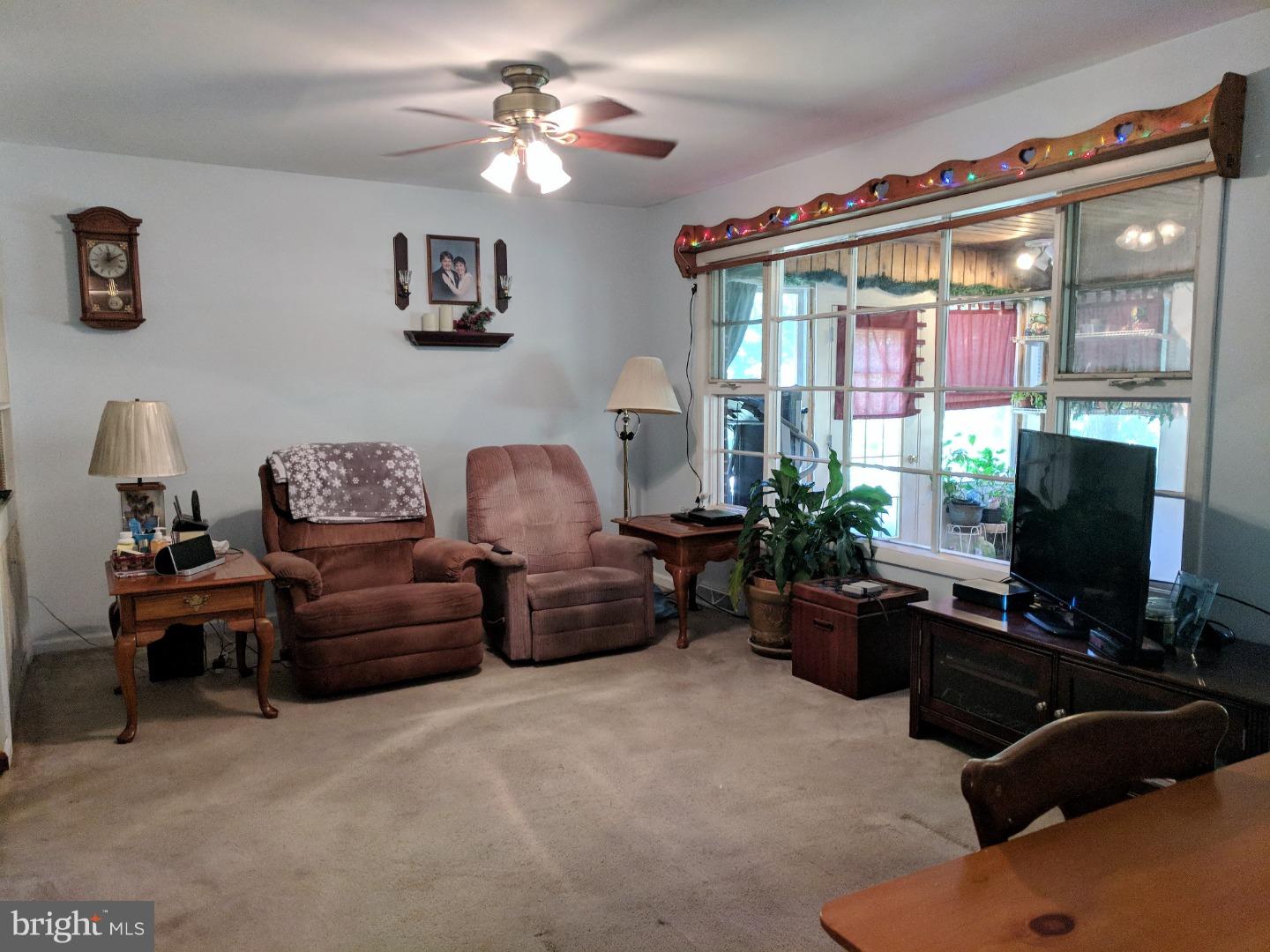 1144 Upper Van Reed Road Leesport, PA 19533 - Photo 8 of 25 a living room with furniture a chandelier and a flat screen tv