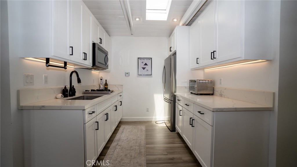 11921 Stamy Road La Mirada, CA 90638 - Photo 11 of 21 a kitchen with a sink stove and cabinets