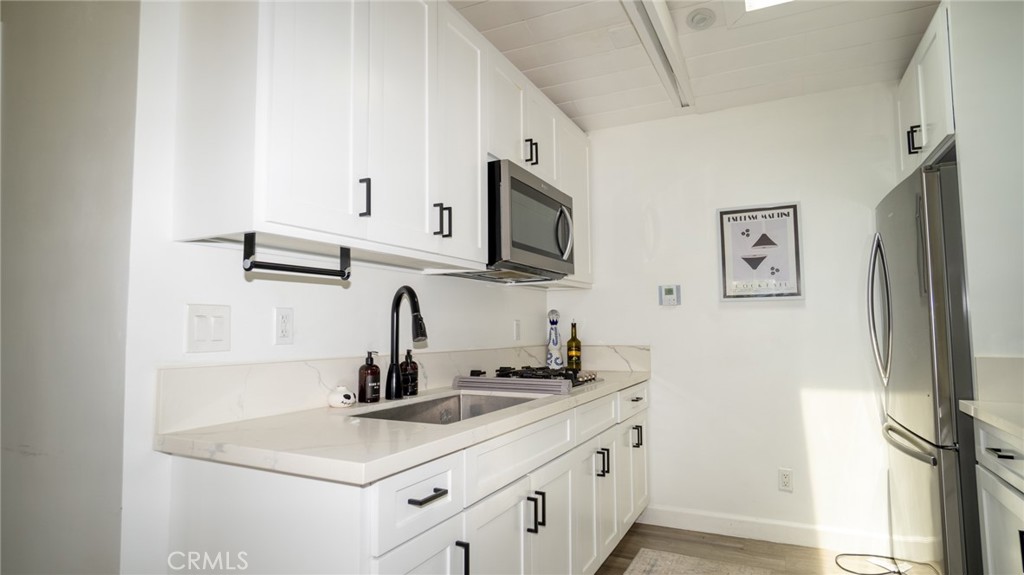 11921 Stamy Road La Mirada, CA 90638 - Photo 12 of 21 a kitchen with stainless steel appliances a sink and a refrigerator