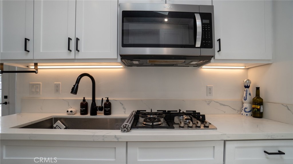 11921 Stamy Road La Mirada, CA 90638 - Photo 13 of 21 a kitchen with a stove and a microwave