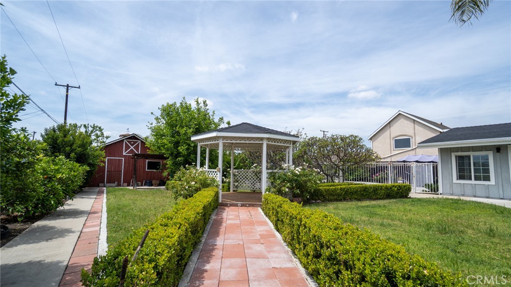 11921 Stamy Road La Mirada, CA 90638 - Photo 20 of 21 a front view of a house with a yard and potted plants