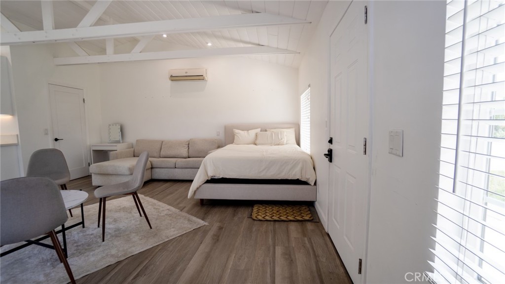 11921 Stamy Road La Mirada, CA 90638 - Photo 5 of 21 a bedroom with a bed and wooden floor